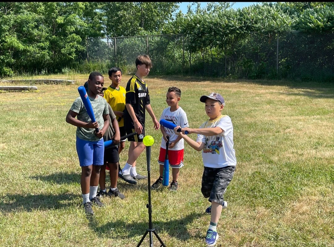 Young batter preparing proper stance on the grass