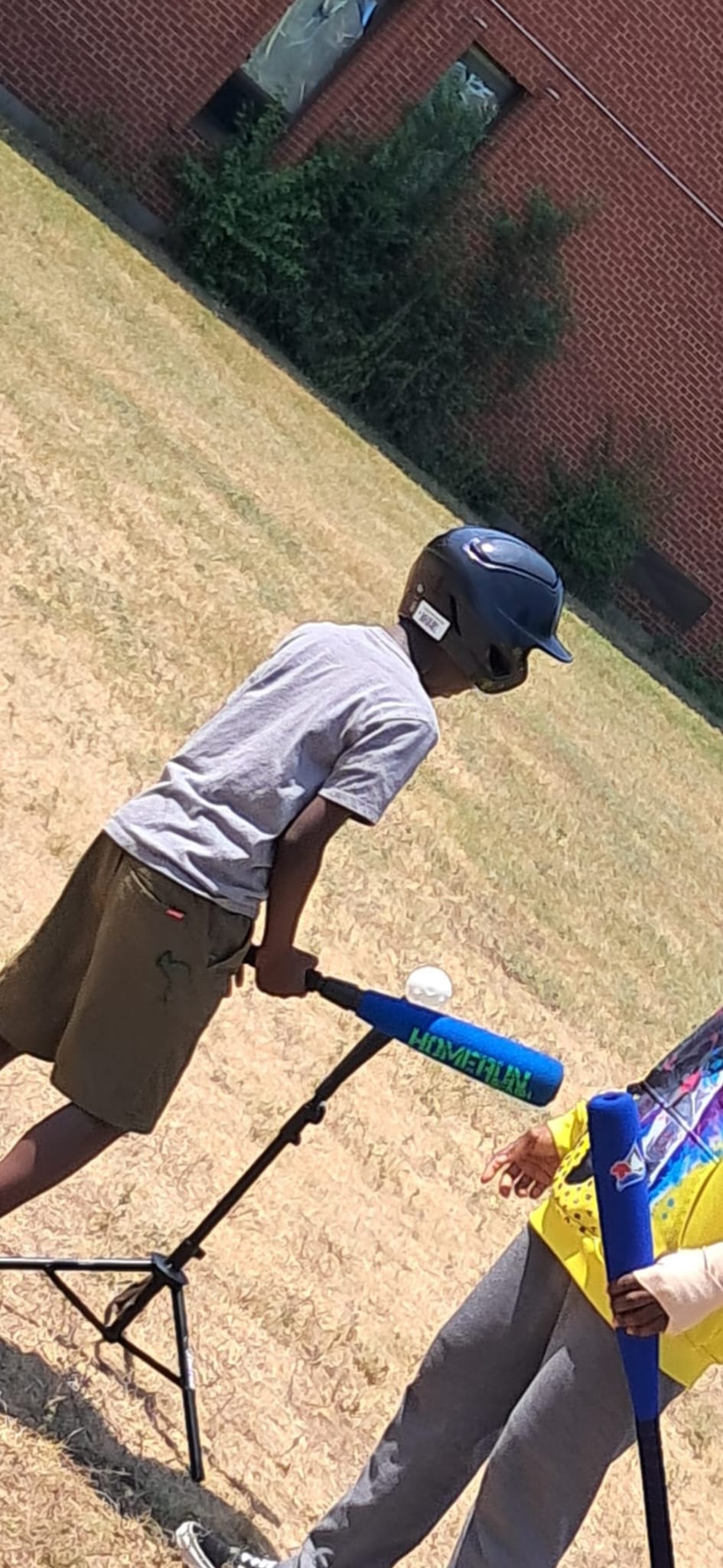 Young batter ready with bat at the tee