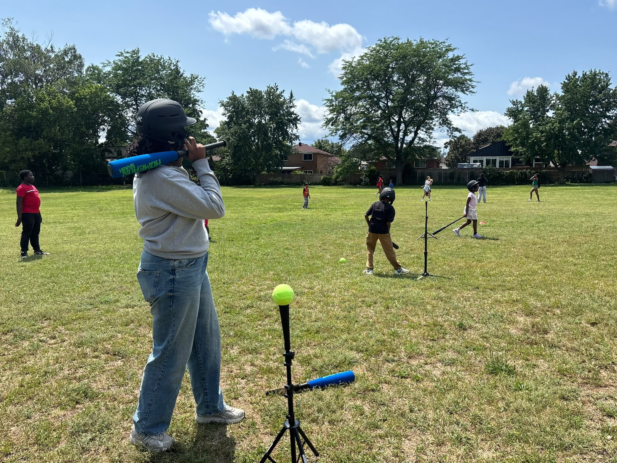 Community mentors guiding young athletes on the pitch in Toronto