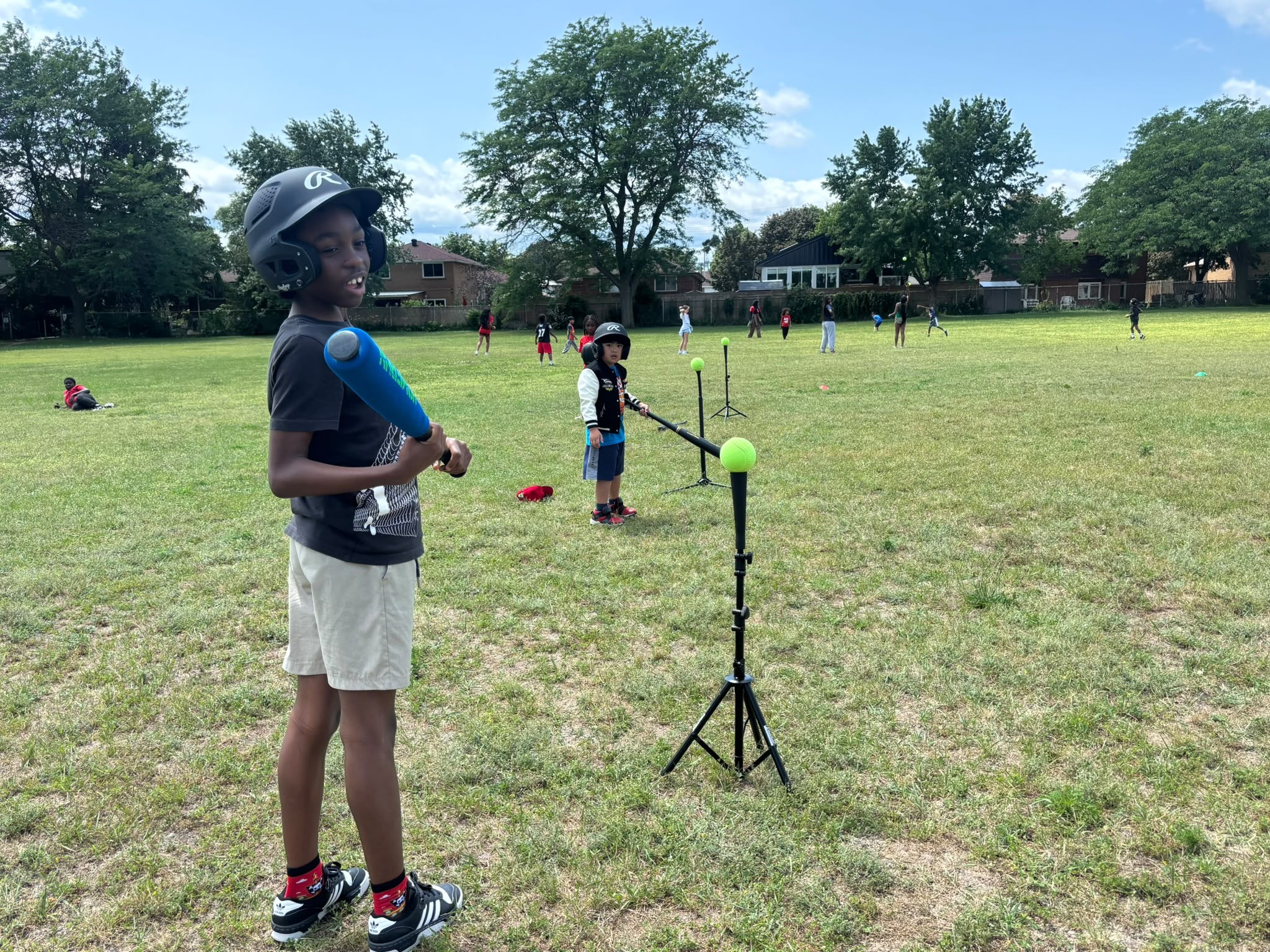 Youth batting tee training under the summer sun in Toronto
