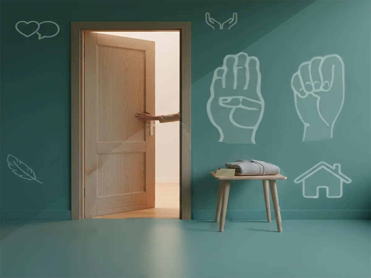 Soft-lit doorway with a small bench holding a folded blanket and resource card, symbolizing domestic violence support in Toronto.